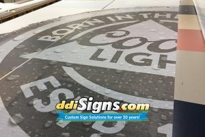 DDI Signs IceFab Mesh, Mesh In Ice Logos, IceFab Under Ice Mesh Logos, Mesh Ice Rink Graphics, Mesh In Ice Logos.