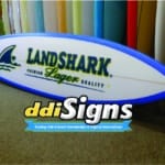 DDI Signs customized surfboard with branding graphic