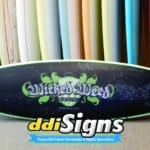 DDI Signs customized surfboard with branding graphics