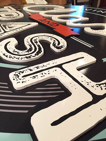 DDI Signs custom signs & Banners. Close up of PVC digitally printed and routed dimensional exterior sign.